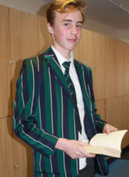 Boy reading by lockers